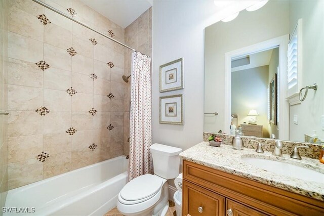 full bathroom with vanity, shower / tub combo, and toilet