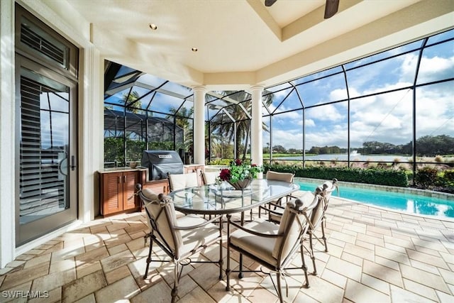 sunroom with ceiling fan and a swimming pool