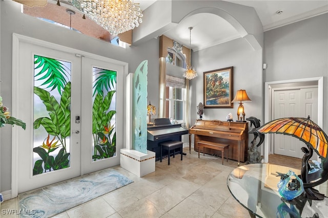 interior space with a chandelier and french doors