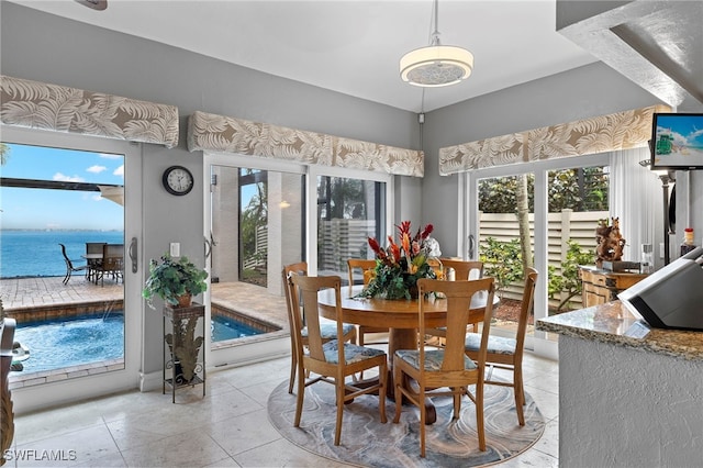 dining room with a water view and plenty of natural light