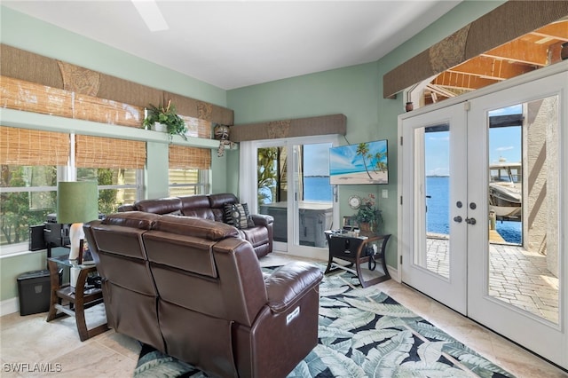 living room featuring plenty of natural light, light tile patterned floors, and french doors