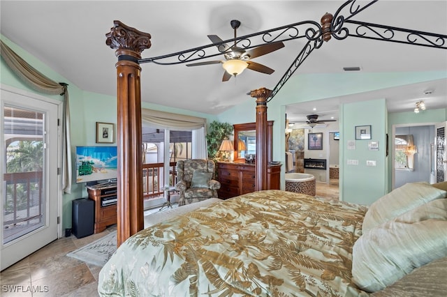 bedroom featuring access to exterior, a fireplace, and vaulted ceiling