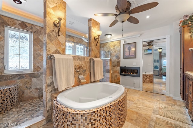 bathroom featuring shower with separate bathtub, vanity, ornamental molding, and a healthy amount of sunlight