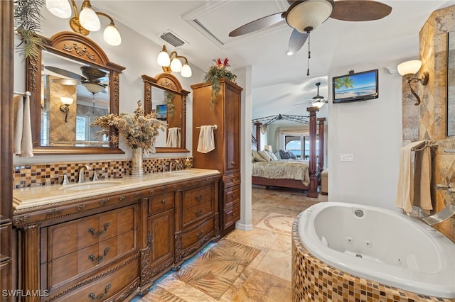 bathroom with vanity and tiled bath