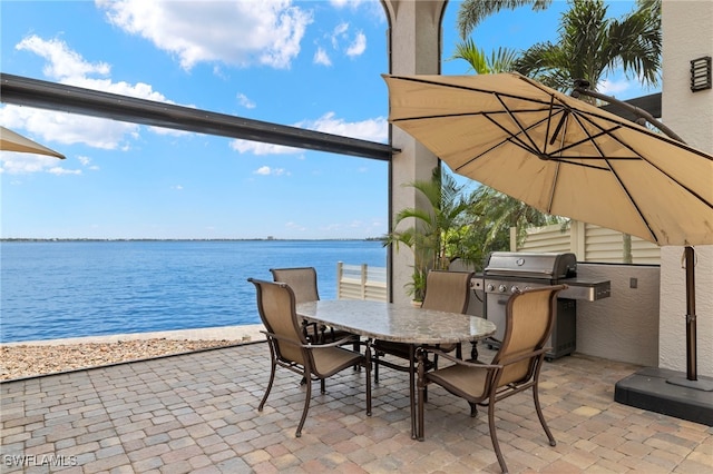 view of patio featuring grilling area and a water view