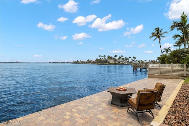 exterior space featuring a fire pit and a water view