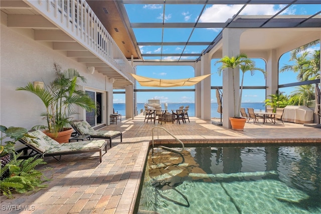 view of swimming pool with a water view