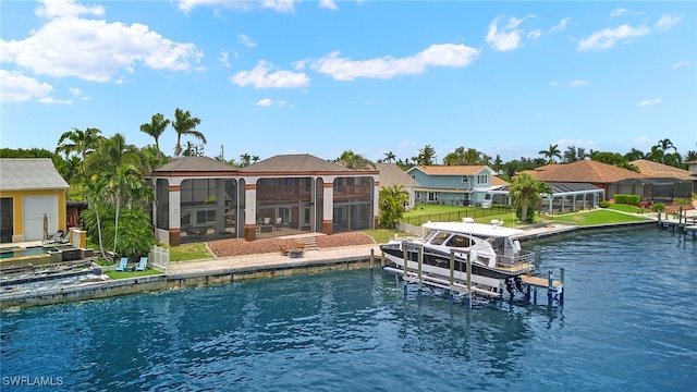 view of pool with a yard, a water view, and a boat dock