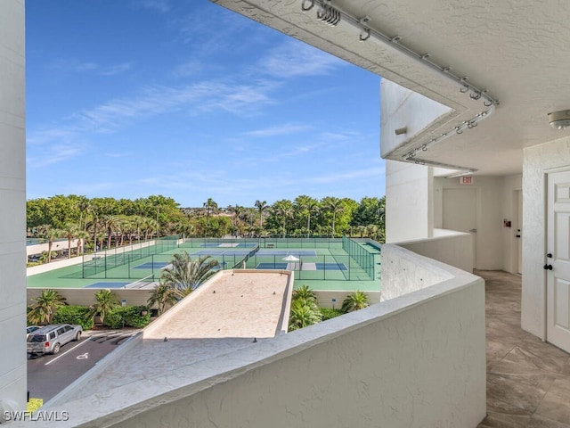 view of pool featuring tennis court