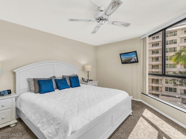 carpeted bedroom with multiple windows and ceiling fan