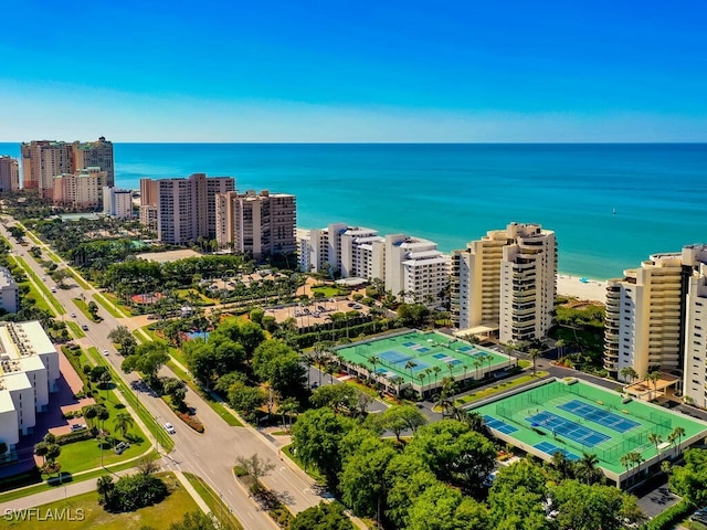 birds eye view of property featuring a beach view and a water view