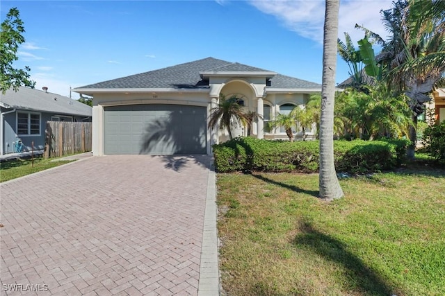 view of front of home featuring a garage and a front yard