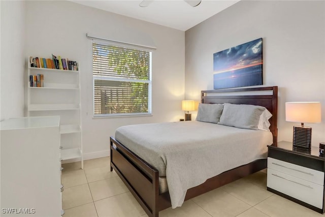 bedroom with light tile patterned floors and baseboards