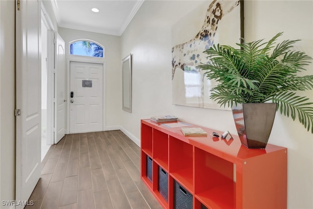 entryway with ornamental molding, recessed lighting, baseboards, and wood finished floors