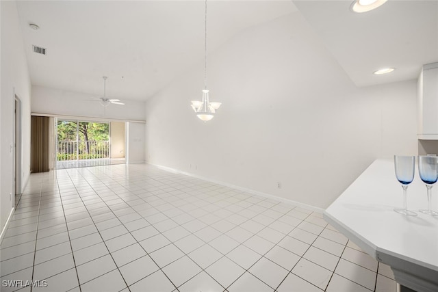 unfurnished living room with ceiling fan, light tile patterned floors, and high vaulted ceiling