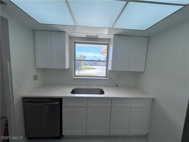 kitchen with dishwasher, light stone counters, and white cabinetry