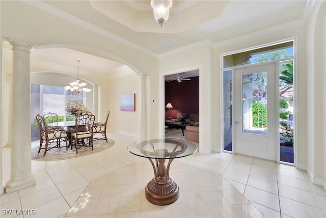 tiled entryway with ornate columns, a wealth of natural light, and crown molding