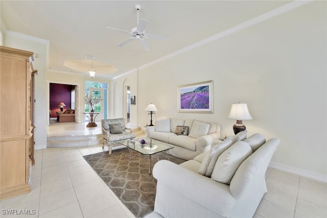 tiled living room with ceiling fan and ornamental molding