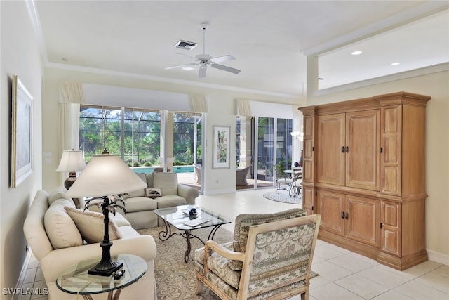 tiled living room with ceiling fan and crown molding