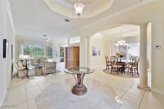 interior space with ceiling fan with notable chandelier, decorative columns, a tray ceiling, and crown molding