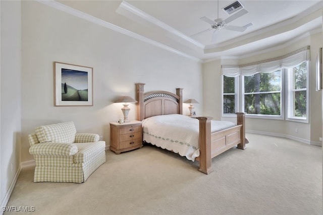 bedroom with a raised ceiling, ceiling fan, carpet floors, and ornamental molding