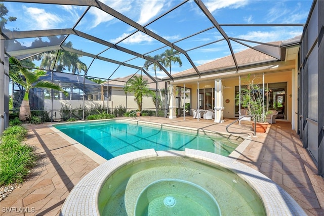 view of swimming pool featuring an in ground hot tub, a patio area, and a lanai