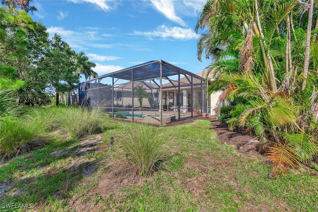 view of yard featuring glass enclosure