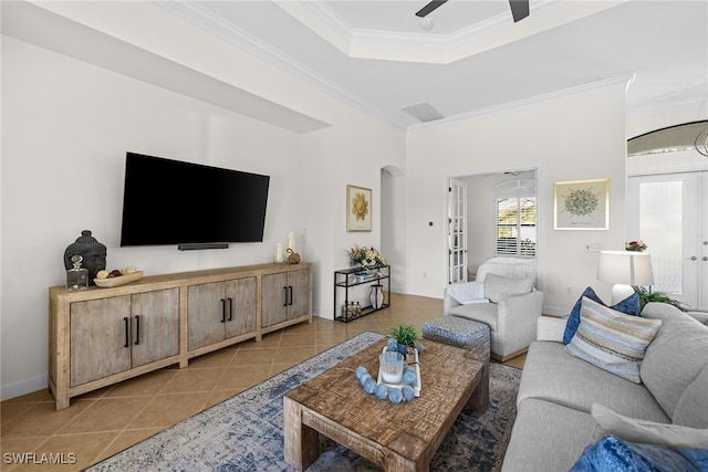 tiled living room with french doors, ceiling fan, and ornamental molding