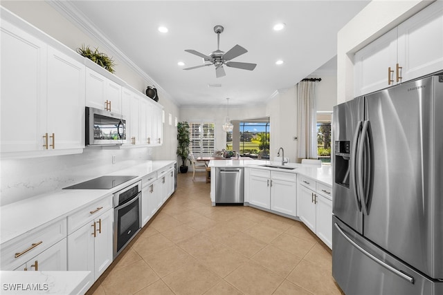 kitchen featuring white cabinetry, sink, ceiling fan, stainless steel appliances, and crown molding