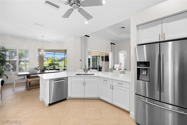 kitchen with white cabinetry, sink, stainless steel appliances, kitchen peninsula, and light tile patterned floors