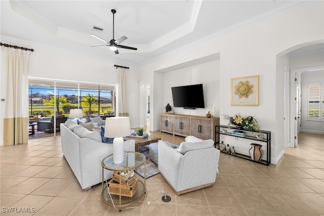 living room featuring plenty of natural light, ceiling fan, and ornamental molding