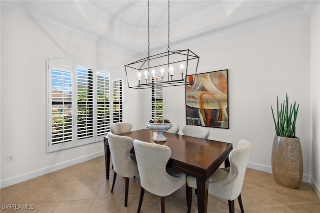 dining room with a tray ceiling, crown molding, light tile patterned floors, and a notable chandelier