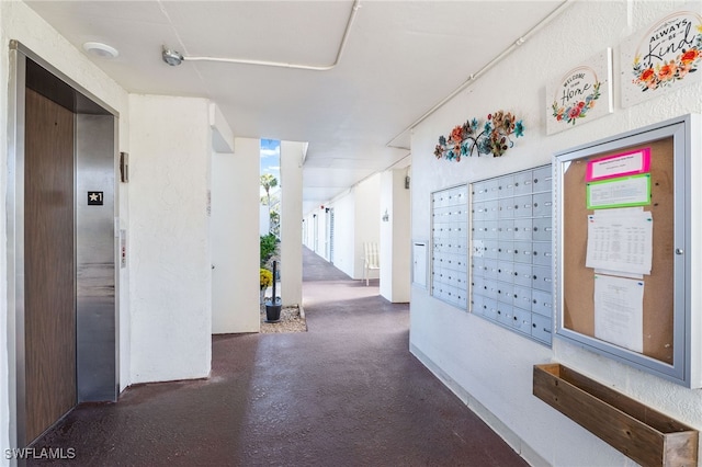 hallway featuring mail area and elevator