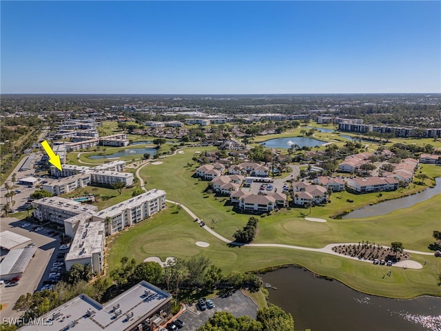 birds eye view of property featuring view of golf course and a water view