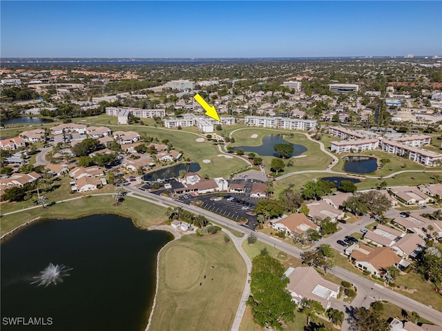 birds eye view of property with a water view, view of golf course, and a residential view