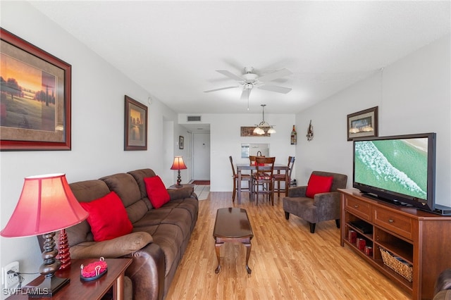 living room featuring ceiling fan, light wood finished floors, and visible vents