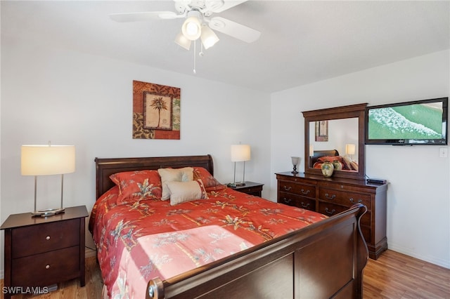 bedroom with ceiling fan and light wood-style flooring