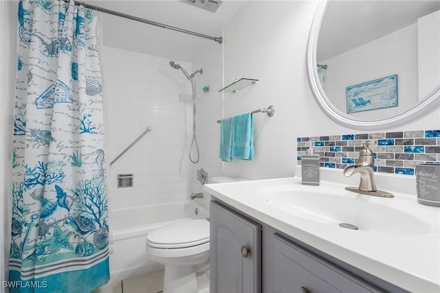 bathroom featuring visible vents, toilet, shower / bath combo with shower curtain, vanity, and tile patterned floors