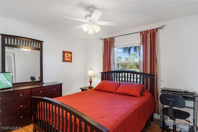 bedroom featuring wood finished floors and a ceiling fan