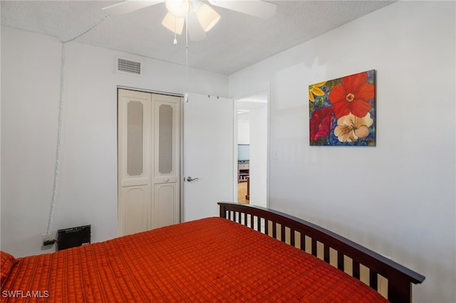 bedroom with a ceiling fan, visible vents, and a closet