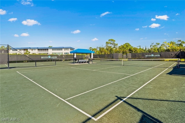 view of tennis court with fence