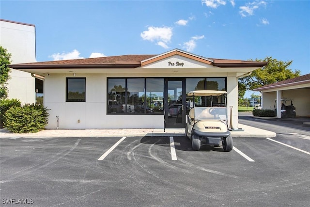 view of building exterior featuring uncovered parking