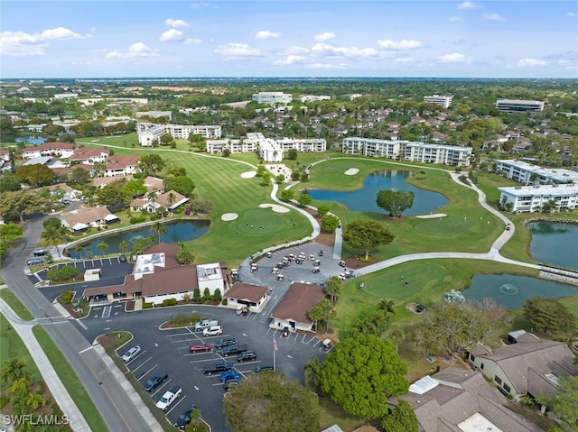 drone / aerial view featuring a water view and golf course view