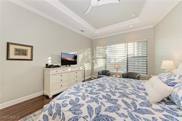 bedroom featuring crown molding, dark wood-type flooring, a raised ceiling, and ceiling fan