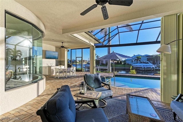 view of patio / terrace with a swimming pool with hot tub, exterior kitchen, ceiling fan, and glass enclosure