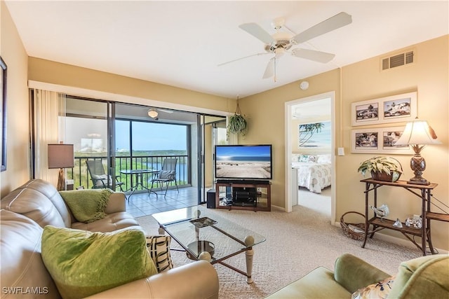 living room with ceiling fan and light colored carpet