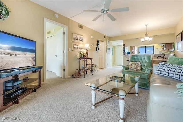 living room featuring ceiling fan with notable chandelier and light colored carpet