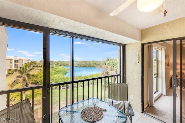 sunroom featuring a water view and plenty of natural light