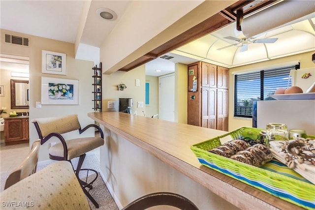 kitchen featuring ceiling fan and light colored carpet