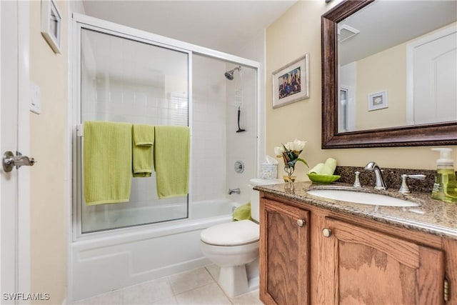 full bathroom featuring toilet, vanity, tile patterned floors, and enclosed tub / shower combo